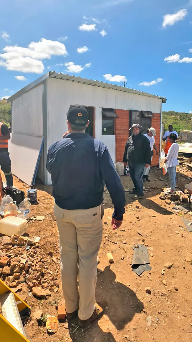 A member of the DigiDeeds team walking across the site towards a newly built home